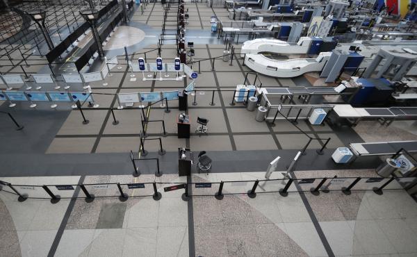 A lone passenger walks past the north checkpoint at Denver International Airport on April 1, which was closed because of a lack of traffic as a statewide stay-at-home order remains in effect to help reduce the spread of the coronavirus. A lone passenger walks past the north checkpoint at Denver International Airport on April 1, which was closed because of a lack of traffic as a statewide stay-at-home order remains in effect to help reduce the spread of the coronavirus.