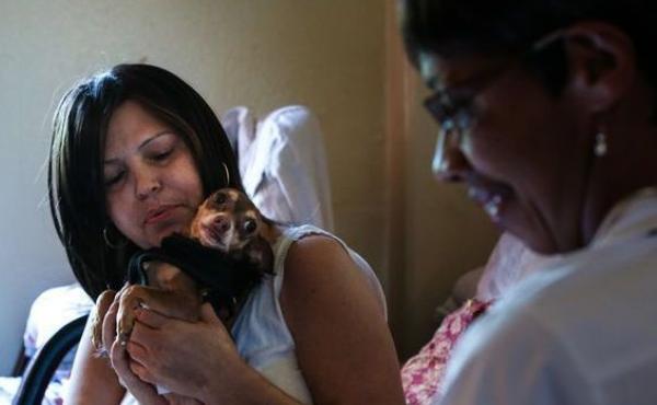 Sandra Lopez (left) and her dog, Coco, greet hospice nurse Heather Meyerend last fall. In the weeks before Lopez died, Meyerend stopped by weekly to check her physical health, pain levels and medications. Sandra Lopez (left) and her dog, Coco, greet hospice nurse Heather Meyerend last fall. In the weeks before Lopez died, Meyerend stopped by weekly to check her physical health, pain levels and medications.