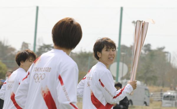 Azusa Iwashimizu (right) and other members of Japan women's national football team run as torchbearers in the first leg of the torch relay for Tokyo Olympics on Thursday in Fukushima prefecture, Japan. Azusa Iwashimizu (right) and other members of Japan women's national football team run as torchbearers in the first leg of the torch relay for Tokyo Olympics on Thursday in Fukushima prefecture, Japan.