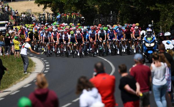Spectators watch cyclists compete in the fourth stage of the Tour de France in eastern France last July. Organizers say the 2020 race will be postponed, though new dates have not been set. Spectators watch cyclists compete in the fourth stage of the Tour de France in eastern France last July. Organizers say the 2020 race will be postponed, though new dates have not been set.