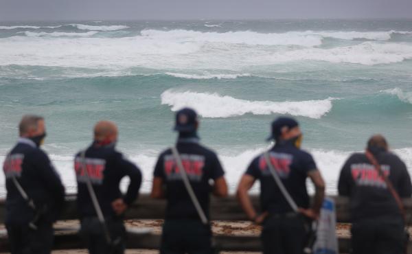 Palm Beach County Fire Rescue check out the ocean as waves crash ashore from Tropical Storm Isaias as it passes through the area on August 2, 2020 in Juno Beach, Fla. Palm Beach County Fire Rescue check out the ocean as waves crash ashore from Tropical Storm Isaias as it passes through the area on August 2, 2020 in Juno Beach, Fla.