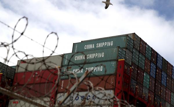 Shipping containers sit on a Hong Kong-based container ship at the Port of Oakland in California last month. The cost of the tariffs is likely to ripple through the global supply chains that make up much of the trade between the U.S. and China. Shipping containers sit on a Hong Kong-based container ship at the Port of Oakland in California last month. The cost of the tariffs is likely to ripple through the global supply chains that make up much of the trade between the U.S. and China.