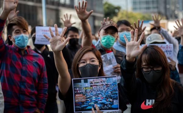 People gather in support of pro-democracy protesters during a lunch break rally in the Kwun Tong area in Hong Kong on Wednesday. Hong Kong has been battered by months of mass rallies and violent clashes between police and protesters who are demanding dire People gather in support of pro-democracy protesters during a lunch break rally in the Kwun Tong area in Hong Kong on Wednesday. Hong Kong has been battered by months of mass rallies and violent clashes between police and protesters who are demanding dire