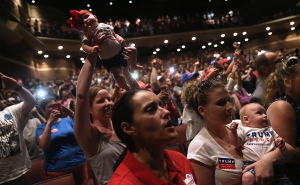 Women hold up their babies for Republican presidential nominee Donald Trump as he speaks at a campaign rally on Aug. 1 in Mechanicsburg, Pa. Women hold up their babies for Republican presidential nominee Donald Trump as he speaks at a campaign rally on Aug. 1 in Mechanicsburg, Pa.