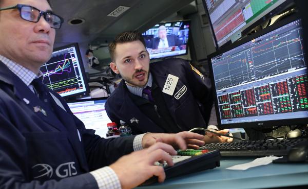 Traders work on the floor of the New York Stock Exchange, which has seen a topsy-turvy couple of days, on Tuesday in New York City. Traders work on the floor of the New York Stock Exchange, which has seen a topsy-turvy couple of days, on Tuesday in New York City.