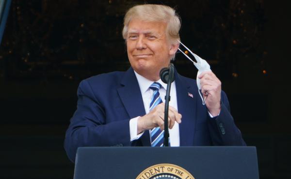 President Trump takes his mask off before speaking from the South Portico of the White House during a rally on Saturday. He is traveling for another rally for the first time on Monday. President Trump takes his mask off before speaking from the South Portico of the White House during a rally on Saturday. He is traveling for another rally for the first time on Monday.
