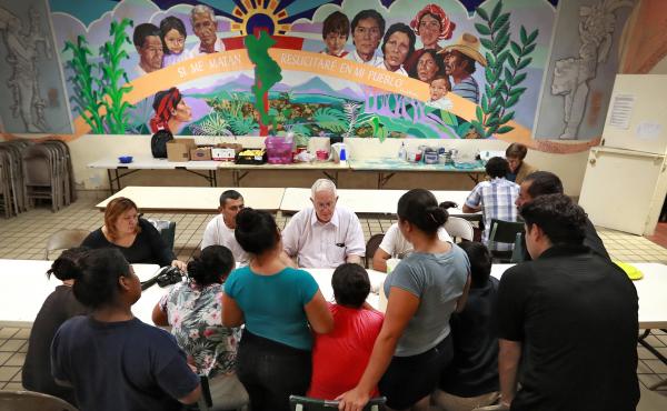 Ruben Garcia (center), director of the Annunciation House, speaks with migrant parents on June 26, 2018, in El Paso, Texas. Ruben Garcia (center), director of the Annunciation House, speaks with migrant parents on June 26, 2018, in El Paso, Texas.