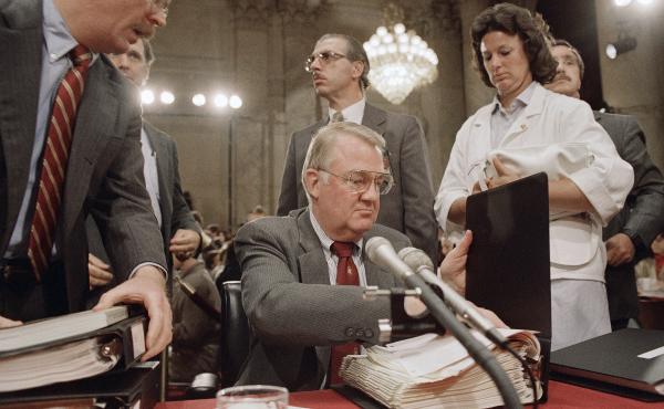 Then-Attorney General Edwin Meese III appears before the congressional committee investigating the Iran-Contra scandal in 1987. Then-Attorney General Edwin Meese III appears before the congressional committee investigating the Iran-Contra scandal in 1987.
