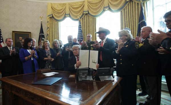 President Trump shows the executive veto of the national emergency resolution in the Oval Office of the White House Friday. President Trump shows the executive veto of the national emergency resolution in the Oval Office of the White House Friday.