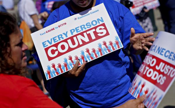 A demonstrator hands out a sign about the 2020 census outside the U.S. Supreme Court in Washington, D.C., in 2019. The Census Bureau is projecting the first set of census numbers won't be ready until February, Trump administration attorneys told a federal A demonstrator hands out a sign about the 2020 census outside the U.S. Supreme Court in Washington, D.C., in 2019. The Census Bureau is projecting the first set of census numbers won't be ready until February, Trump administration attorneys told a federal