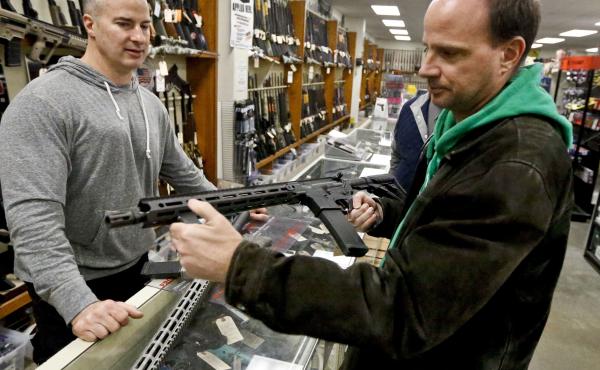 Wes Morosky, owner of Duke's Sport Shop. left, helps Ron Detka as he shops for a rifle at his store in New Castle, Penn. Wes Morosky, owner of Duke's Sport Shop. left, helps Ron Detka as he shops for a rifle at his store in New Castle, Penn.