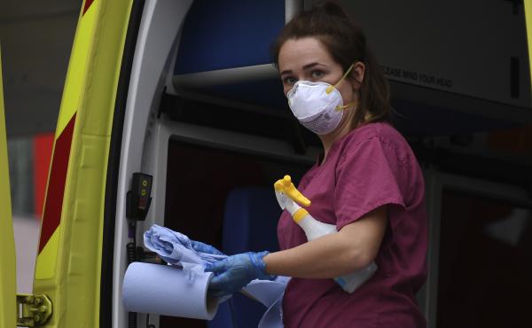 A medical worker cleans an ambulance at St. Thomas' Hospital, one of the many hospitals dealing with coronavirus patients in London. U.K. health care personnel say they are not receiving enough tests for the virus themselves. A medical worker cleans an ambulance at St. Thomas' Hospital, one of the many hospitals dealing with coronavirus patients in London. U.K. health care personnel say they are not receiving enough tests for the virus themselves.