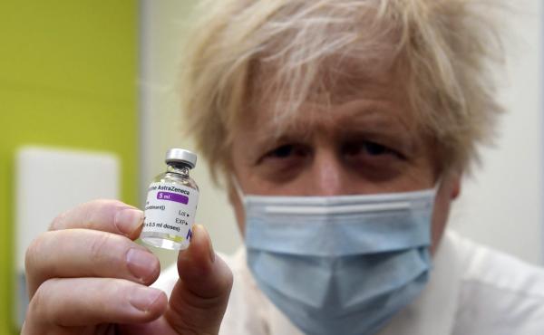 Britain's Prime Minister Boris Johnson holds a vial of the AstraZeneca vaccine during a visit to a coronavirus vaccination center in London on Feb. 15, 2021. The British government hopes to vaccinate all adults by the end of July. Britain's Prime Minister Boris Johnson holds a vial of the AstraZeneca vaccine during a visit to a coronavirus vaccination center in London on Feb. 15, 2021. The British government hopes to vaccinate all adults by the end of July.