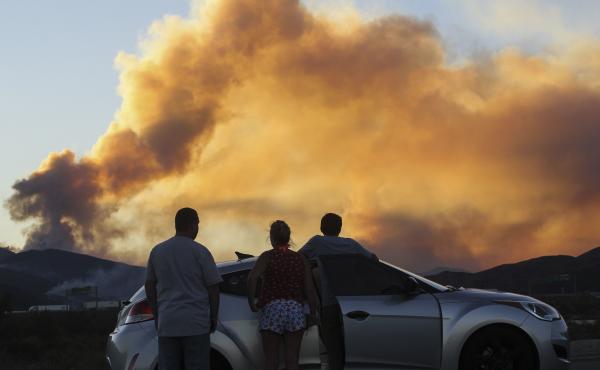 People watch the Blue Cut Fire in Lytle Creek, Calif., in 2016. People watch the Blue Cut Fire in Lytle Creek, Calif., in 2016.