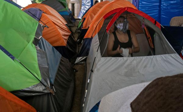 Mexican asylum seeker Eily Sanchez cleans her tent at a migrant shelter in Tijuana, Mexico, last month. Mexican asylum seeker Eily Sanchez cleans her tent at a migrant shelter in Tijuana, Mexico, last month.