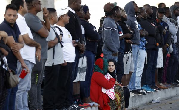 People wait in Tijuana, Mexico, on Tuesday to apply for asylum in the United States. A memo notified officers that immigrants at the southern border are ineligible for asylum, with a few exceptions. People wait in Tijuana, Mexico, on Tuesday to apply for asylum in the United States. A memo notified officers that immigrants at the southern border are ineligible for asylum, with a few exceptions.