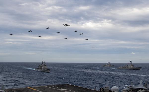 Aircraft assigned to Carrier Air Wing (CVW) 17 fly over the Theodore Roosevelt Carrier Strike Group and the Nimitz Carrier Strike Group in the South China Sea on Tuesday. Aircraft assigned to Carrier Air Wing (CVW) 17 fly over the Theodore Roosevelt Carrier Strike Group and the Nimitz Carrier Strike Group in the South China Sea on Tuesday.