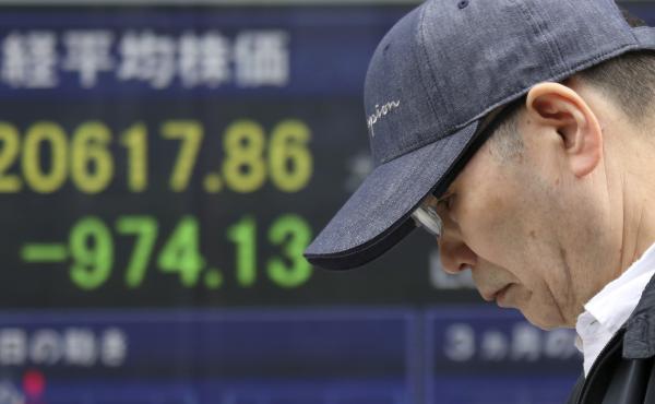 A man walks by an electronic stock board of a securities firm in Tokyo, on Friday. Asian stock markets slumped after Beijing responded to the Trump administration's tariff hikes by saying it may order higher import duties on a range of U.S. goods. A man walks by an electronic stock board of a securities firm in Tokyo, on Friday. Asian stock markets slumped after Beijing responded to the Trump administration's tariff hikes by saying it may order higher import duties on a range of U.S. goods.