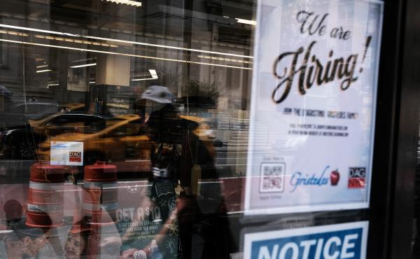 A hiring sign gets displayed in a store window in New York City in August. Last month saw a sharp slowdown in hiring from previous months as the pandemic wears on and creates uncertainty. A hiring sign gets displayed in a store window in New York City in August. Last month saw a sharp slowdown in hiring from previous months as the pandemic wears on and creates uncertainty.