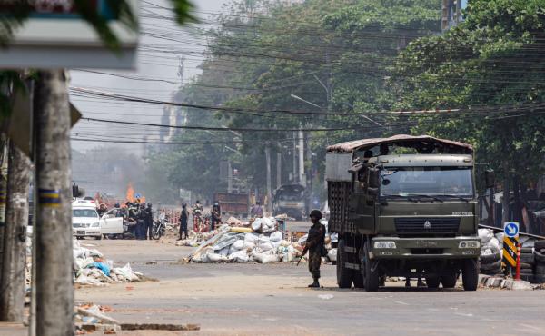 Security forces stand guard on a road as people are arrested, next to dismantled barricades that were set up by protesters demonstrating against the military coup, in Yangon, Myanmar, on Friday. Security forces stand guard on a road as people are arrested, next to dismantled barricades that were set up by protesters demonstrating against the military coup, in Yangon, Myanmar, on Friday.