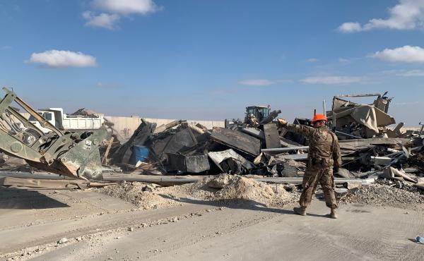 U.S. troops clear debris following an Iranian missile strike at the Ain al-Assad air base in Iraq on Jan. 8. No one was killed, and U.S. officials initially said no American service members had been injured. U.S. troops clear debris following an Iranian missile strike at the Ain al-Assad air base in Iraq on Jan. 8. No one was killed, and U.S. officials initially said no American service members had been injured.