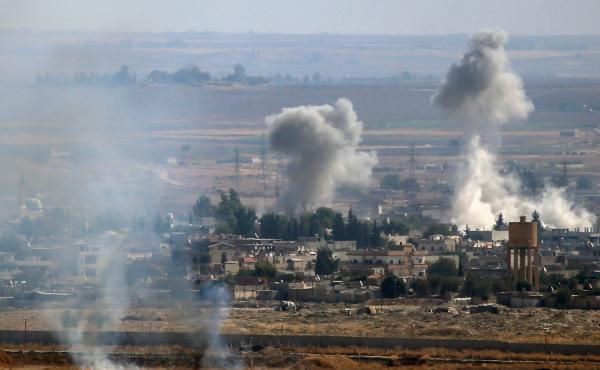 A photo taken from Turkey's Sanliurfa province shows smoke rising after Turkish armed forces hit targets in Ras al-Ain, a town east of the Euphrates River in northern Syria, on Monday. A photo taken from Turkey's Sanliurfa province shows smoke rising after Turkish armed forces hit targets in Ras al-Ain, a town east of the Euphrates River in northern Syria, on Monday.