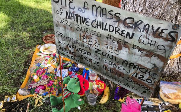 A makeshift memorial for the dozens of Indigenous children who died more than a century ago while attending a boarding school that was once located nearby is displayed under a tree at a public park in Albuquerque, N.M., in 2021. A makeshift memorial for the dozens of Indigenous children who died more than a century ago while attending a boarding school that was once located nearby is displayed under a tree at a public park in Albuquerque, N.M., in 2021.