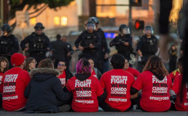 Police surround McDonald's restaurant employees who were sitting in an intersection in Los Angeles after walking off the job to demand a $15 minimum wage and union rights during nationwide "Fight for $15" protests on Tuesday. Police surround McDonald's restaurant employees who were sitting in an intersection in Los Angeles after walking off the job to demand a $15 minimum wage and union rights during nationwide "Fight for $15" protests on Tuesday.
