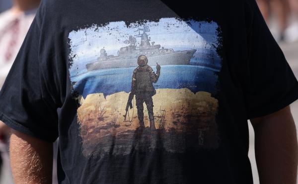 A T-shirt, worn at a Berlin rally this month to support European aid to Ukraine, celebrates the Ukrainian soldiers on Snake Island who refused to surrender to Russian naval forces. A T-shirt, worn at a Berlin rally this month to support European aid to Ukraine, celebrates the Ukrainian soldiers on Snake Island who refused to surrender to Russian naval forces.
