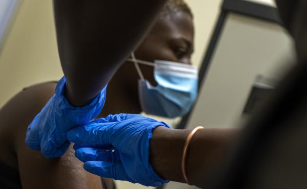 A volunteer receives a shot as part of a COVID-19 vaccine trial at Soweto's Chris Sani Baragwanath Hospital outside Johannesburg, South Africa, on Nov. 30, 2020. A volunteer receives a shot as part of a COVID-19 vaccine trial at Soweto's Chris Sani Baragwanath Hospital outside Johannesburg, South Africa, on Nov. 30, 2020.