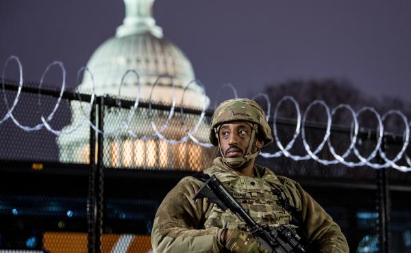 A member of the Virginia National Guard stands outside the razor wire fencing surrounding the U.S. Capitol on Friday. Up to 25,000 troops are expected by Inauguration Day. A member of the Virginia National Guard stands outside the razor wire fencing surrounding the U.S. Capitol on Friday. Up to 25,000 troops are expected by Inauguration Day.