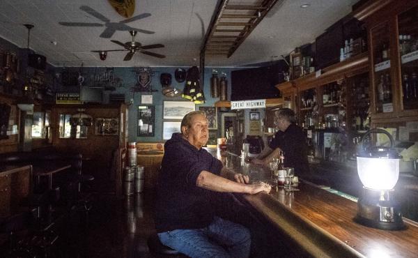 Joseph Pokorski drinks a beer at The Town Square as downtown Sonoma, Calif., remains without power on Wednesday. Joseph Pokorski drinks a beer at The Town Square as downtown Sonoma, Calif., remains without power on Wednesday.