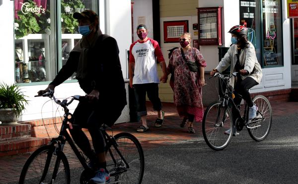 Pedestrians and cyclists head down Commercial Street in Provincetown, Mass., in May 2020. A study of a new outbreak in Provincetown found that three-quarters of those infected with the virus were fully vaccinated. Pedestrians and cyclists head down Commercial Street in Provincetown, Mass., in May 2020. A study of a new outbreak in Provincetown found that three-quarters of those infected with the virus were fully vaccinated.