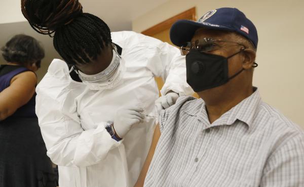 A health care worker administers the COVID-19 vaccine to a resident in Tampa, Fla., on Jan. 10. Seniors in Florida's Leon County have had trouble signing up for the vaccine and a local reporter tried to help them. A health care worker administers the COVID-19 vaccine to a resident in Tampa, Fla., on Jan. 10. Seniors in Florida's Leon County have had trouble signing up for the vaccine and a local reporter tried to help them.