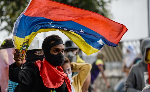 An anti-Maduro demonstrator waves the Venezuelan flag at a protest in the capital, Caracas, on Wednesday. The government banned such demonstrations nationwide for the next five days, as the country approaches a Sunday vote on delegates for Maduro's consti An anti-Maduro demonstrator waves the Venezuelan flag at a protest in the capital, Caracas, on Wednesday. The government banned such demonstrations nationwide for the next five days, as the country approaches a Sunday vote on delegates for Maduro's consti