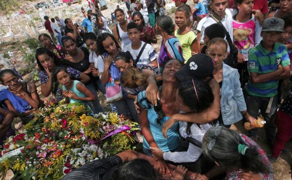 Relatives grieve during the funeral of some of the victims of the prison fire, in Valencia, northern Carabobo state, Venezuela, last week. Relatives grieve during the funeral of some of the victims of the prison fire, in Valencia, northern Carabobo state, Venezuela, last week.