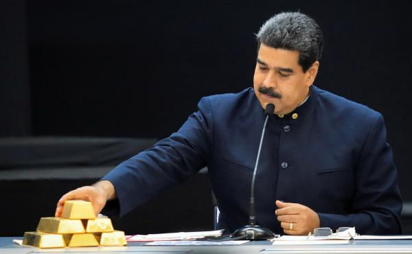 Venezuelan President Nicolás Maduro touches a gold bar as he speaks with economic officials at Miraflores Palace in Caracas in March. Venezuelan President Nicolás Maduro touches a gold bar as he speaks with economic officials at Miraflores Palace in Caracas in March.