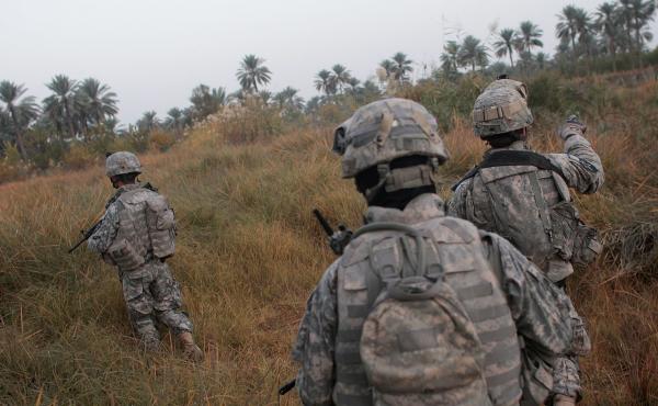 U.S. soldiers traverse fields on the way to conducting house-to- house searches in 2007 in Mukhisa, Iraq. U.S. soldiers traverse fields on the way to conducting house-to- house searches in 2007 in Mukhisa, Iraq.