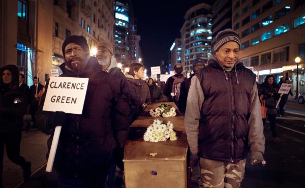 Vigil attendees march down 14th Street NW in Washington, D.C., carrying a casket memorializing the homeless who died this year Vigil attendees march down 14th Street NW in Washington, D.C., carrying a casket memorializing the homeless who died this year