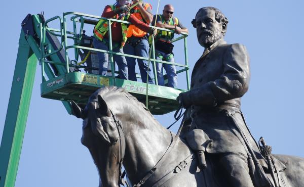 A crew from the Virginia Department of General Services takes measurements as they inspect the statue of Confederate Gen. Robert E. Lee on Monument Avenue on Monday. A crew from the Virginia Department of General Services takes measurements as they inspect the statue of Confederate Gen. Robert E. Lee on Monument Avenue on Monday.