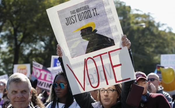 Women gather for a rally and march at Grant Park on Saturday in Chicago to urge voter turnout ahead of the midterm elections. Women gather for a rally and march at Grant Park on Saturday in Chicago to urge voter turnout ahead of the midterm elections.