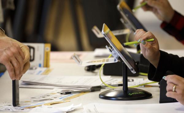 An election worker uses an electronic pollbook to check voters at a polling station in the Echo Park Recreation Complex in Los Angeles on March 3, 2020. An election worker uses an electronic pollbook to check voters at a polling station in the Echo Park Recreation Complex in Los Angeles on March 3, 2020.