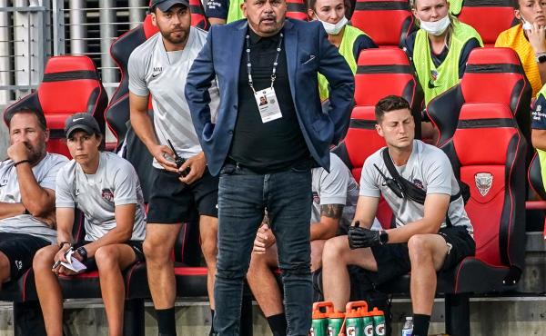 Coach Richie Burke of the Washington Spirit watches the play during a game against the North Carolina Courage at Audi Field on July 10, 2021 in Washington, DC. Coach Richie Burke of the Washington Spirit watches the play during a game against the North Carolina Courage at Audi Field on July 10, 2021 in Washington, DC.