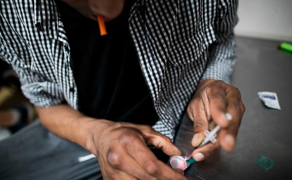 A drug user prepares a hit of heroin inside VANDU's supervised injection room. A drug user prepares a hit of heroin inside VANDU's supervised injection room.