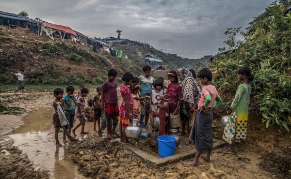 Rohingya refugees collect drinking water from a pump in a camp in Bangladesh. Rohingya refugees collect drinking water from a pump in a camp in Bangladesh.