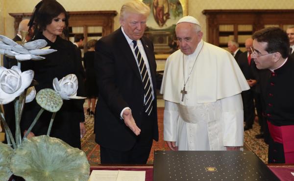 Pope Francis exchanges gifts with President Trump and his wife, Melania, at the Vatican on Wednesday. Pope Francis exchanges gifts with President Trump and his wife, Melania, at the Vatican on Wednesday.