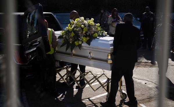 A casket is loaded into a hearse at the Boyd Funeral Home as burials at cemeteries are delayed to the surge of COVID-19 deaths on Jan. 14, 2021 in Los Angeles. A casket is loaded into a hearse at the Boyd Funeral Home as burials at cemeteries are delayed to the surge of COVID-19 deaths on Jan. 14, 2021 in Los Angeles.