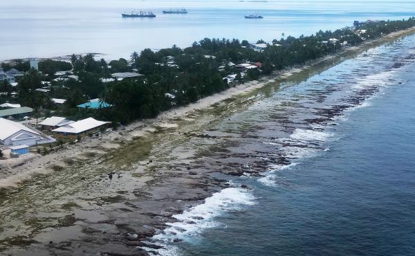 The ocean (right) and the lagoon (left) are separated by a thin strip of land in Funafuti, Tuvalu. The small South Pacific island nation is striving to mitigate the effects of climate change. Tuvalu's 11,000 inhabitants see effects such as rising sea leve The ocean (right) and the lagoon (left) are separated by a thin strip of land in Funafuti, Tuvalu. The small South Pacific island nation is striving to mitigate the effects of climate change. Tuvalu's 11,000 inhabitants see effects such as rising sea leve