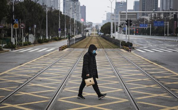 A resident walks across an empty track on Feb. 7 in Wuhan, China. Wuhan residents lived through the start of the coronavirus pandemic, which has claimed hundreds of thousands of lives around the world. A resident walks across an empty track on Feb. 7 in Wuhan, China. Wuhan residents lived through the start of the coronavirus pandemic, which has claimed hundreds of thousands of lives around the world.