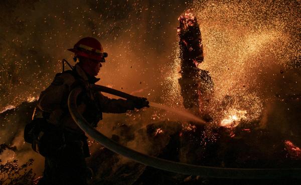 Jason Marone cools down a hot spot burning close to homes last week in the Christmas Valley area of Meyers, Calif. Jason Marone cools down a hot spot burning close to homes last week in the Christmas Valley area of Meyers, Calif.